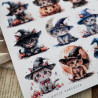 Zbliżenie na wydrukowany arkusz z 12 słodkimi halloweenowymi grafikami kotów,