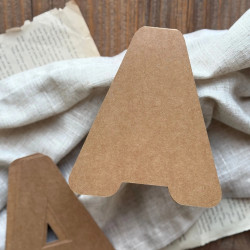 Baza do kartki handmade w kształcie litery A oraz papierowe wzorniki ułożone na ozdobnym tle.
